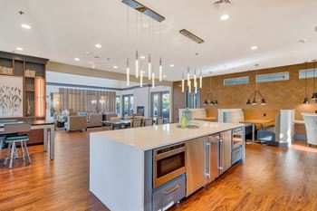 Resident clubhouse with large tv, lounge area, kitchen, and complimentary wi-fi